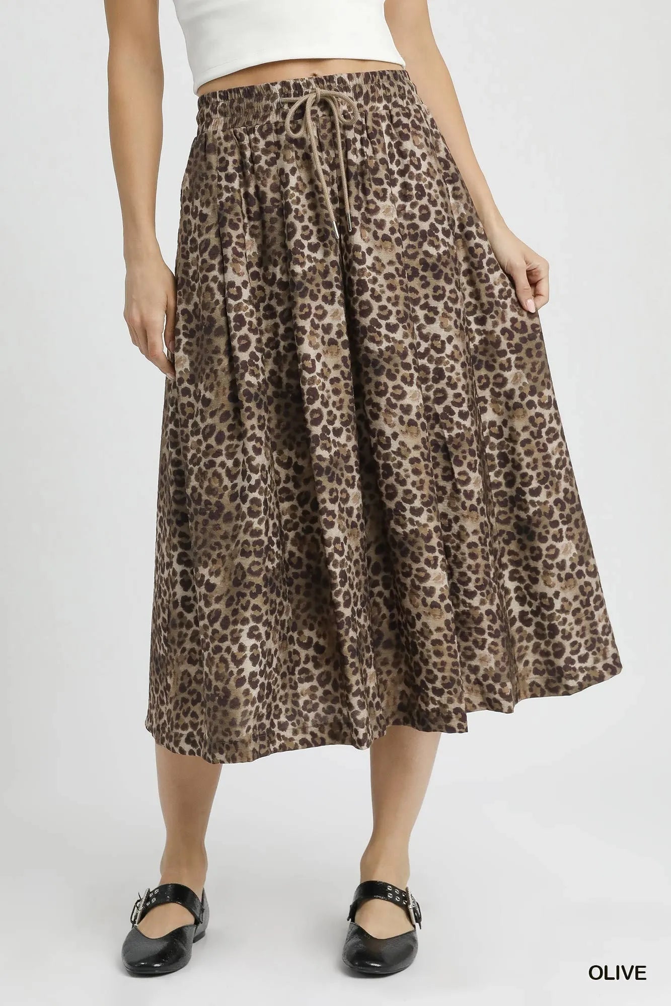 Olive green Umgee drawstring leopard midi skirt with a relaxed fit and mid-length design, styled with a casual, trendy look.