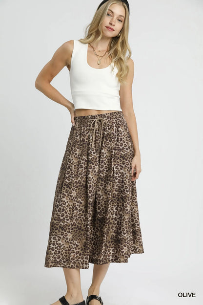 Olive green Umgee drawstring leopard midi skirt with a relaxed fit, featuring a waist tie and stylish animal print.