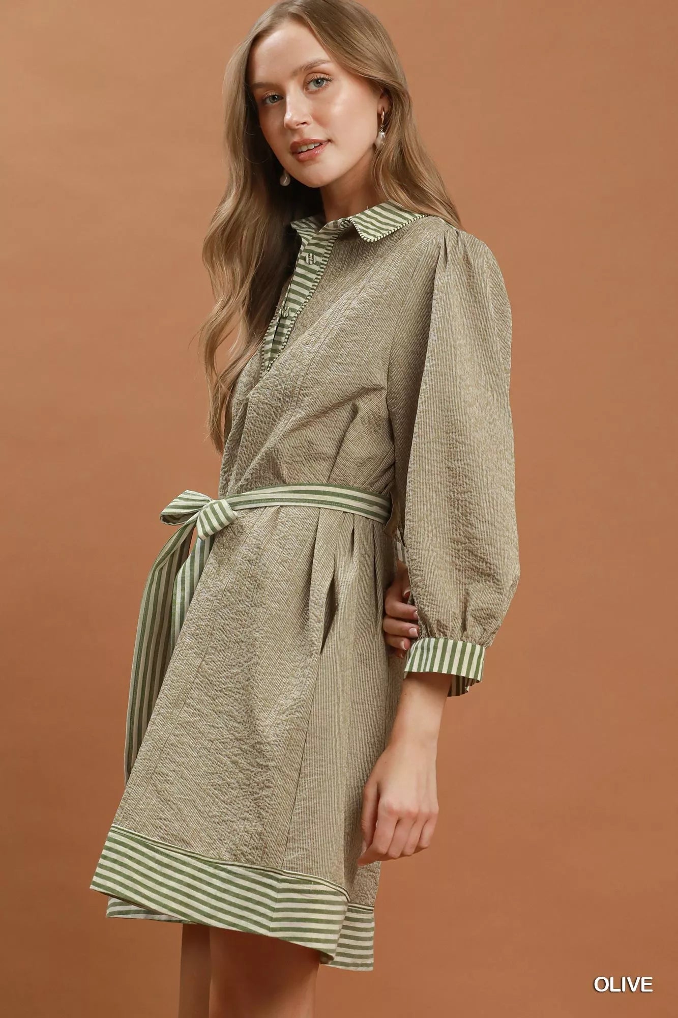 Olive green Umgee striped contrast belted puff sleeve mini dress with a fitted silhouette and stylish design.
