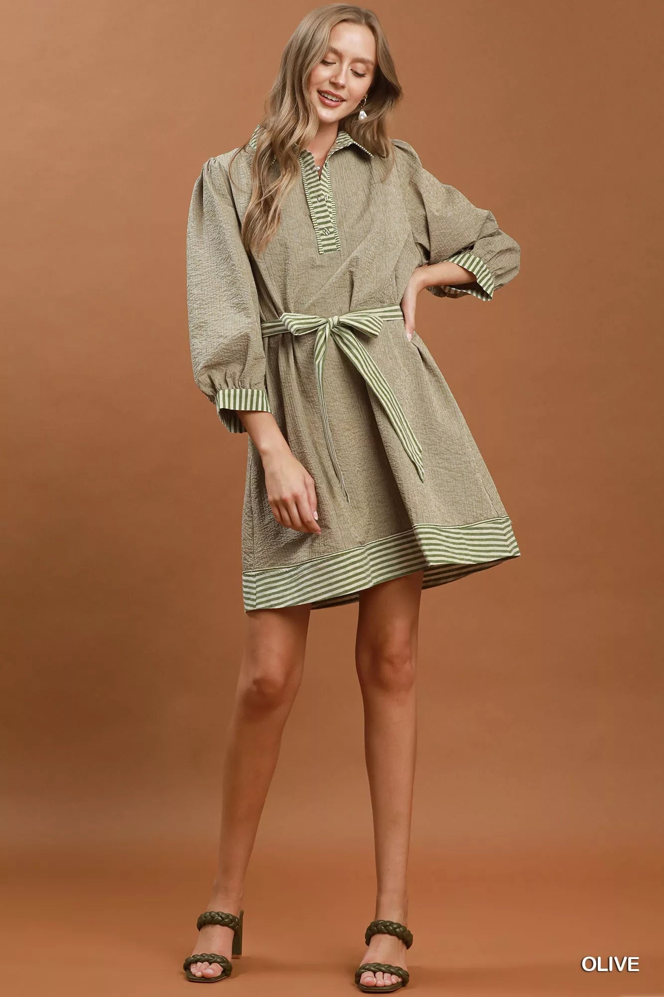 Olive green Umgee mini dress with striped contrast, puff sleeves, belted waist, perfect for casual or semi-formal wear