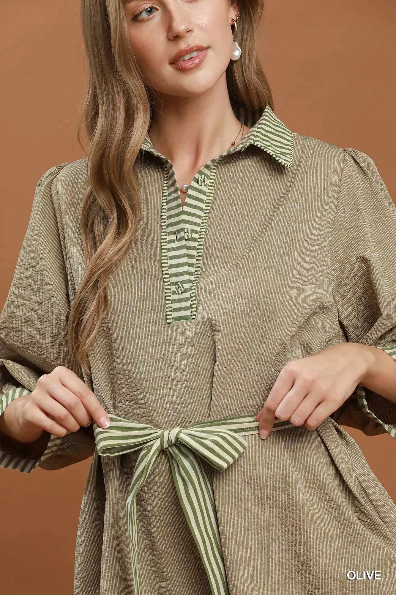 Olive green Umgee striped contrast belted puff sleeve mini dress with a cinched waist and stylish design, perfect for casual wear.