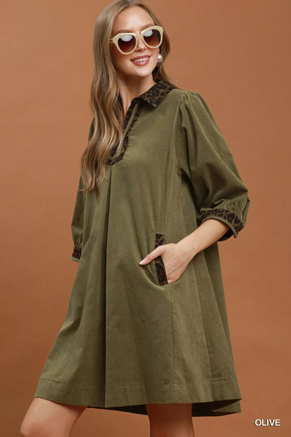 Olive green Umgee V-Neck Shift Dress with contrast trim, short sleeves, and relaxed fit, styled for casual wear.