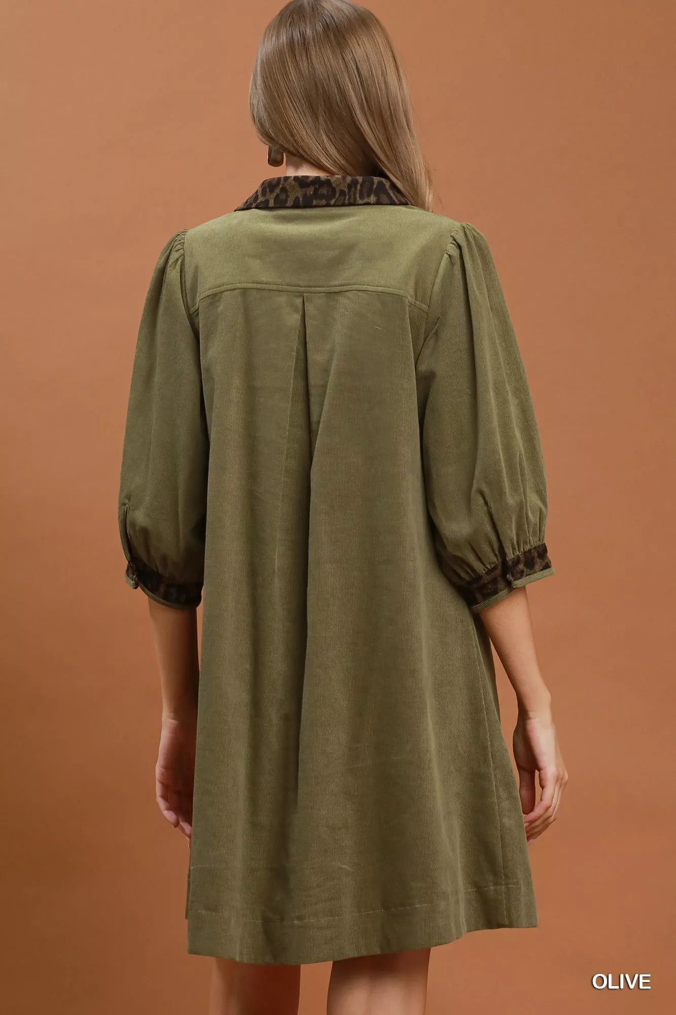 Olive green Umgee V-neck shift dress with contrast trim, short sleeves, and relaxed fit, showcased on a model.