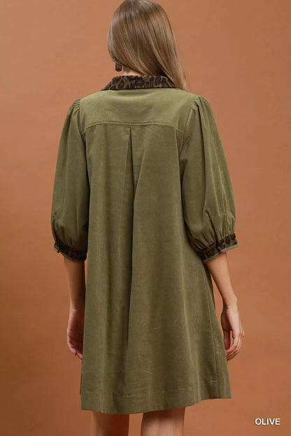 Olive green Umgee V-neck shift dress with contrast trim, short sleeves, and relaxed fit, showcased on a model.