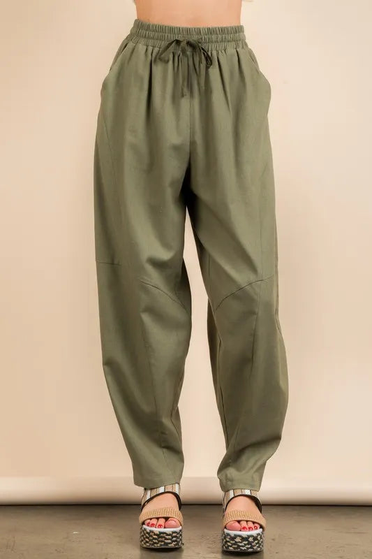 Olive green Very J Solid Barrel Comfy Woven Pants by Trendsi, featuring relaxed fit and soft woven fabric, shown on a model.