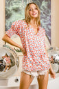 Trendsi BiBi Floral V-neck top with smoked puff sleeves in orange floral print, lightweight and stylish for casual wear.