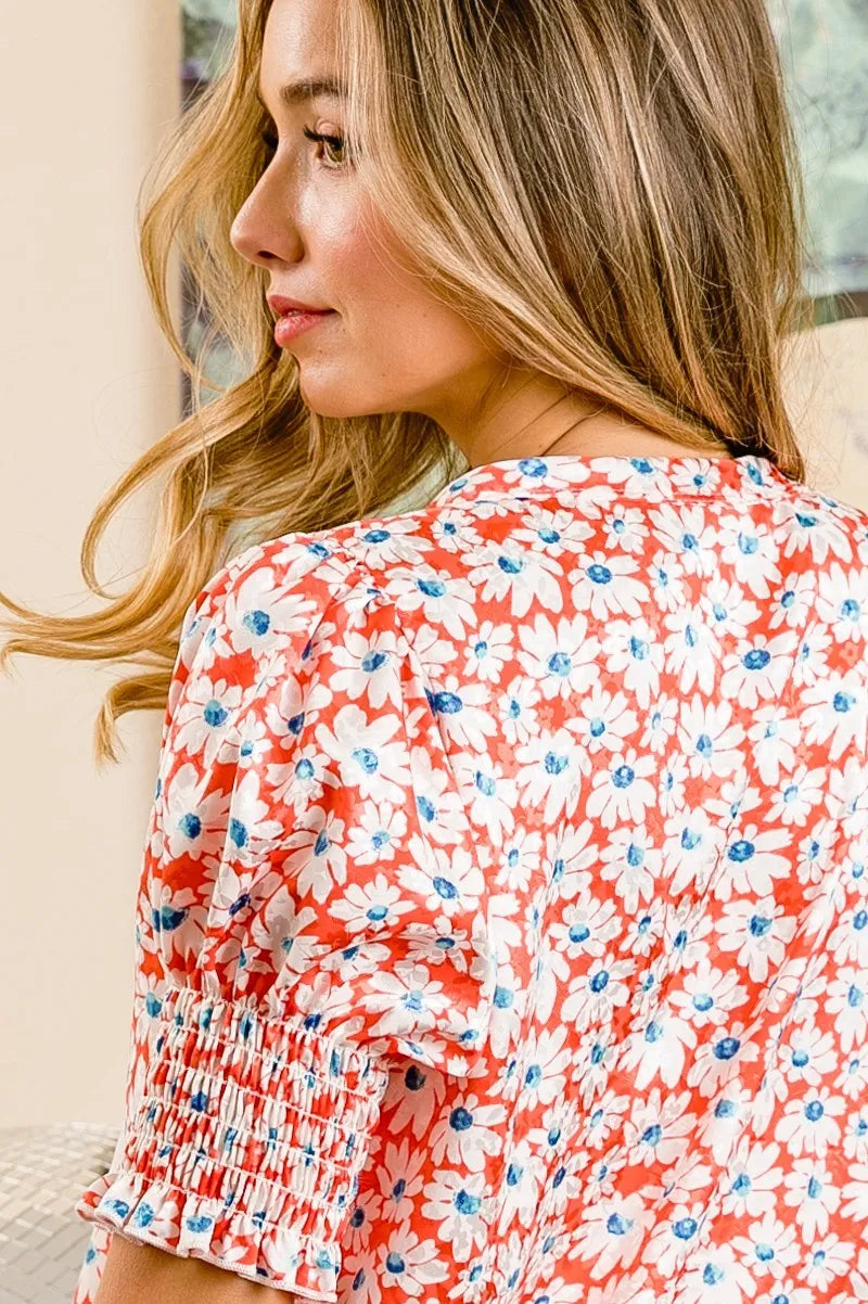 Trendsi BiBi floral V-neck top with smoked puff sleeves in orange and floral pattern, lightweight and stylish for casual wear.
