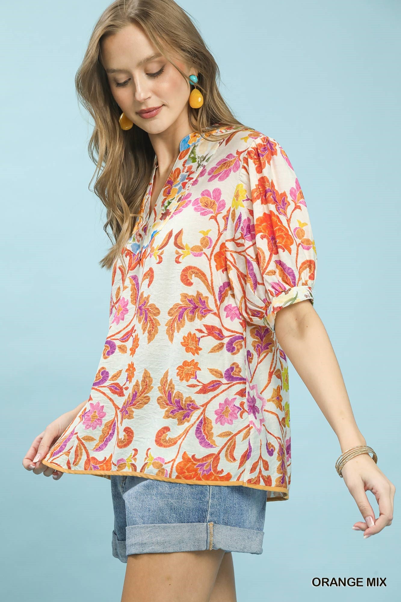 Orange floral split-neck short sleeve top by Umgee, trendy casual blouse with mixed floral pattern and relaxed fit.
