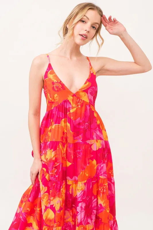 Orange multi floral tiered maxi cami dress with pockets from And The Why by Trendsi, showcasing a flowy, sleeveless summer style.