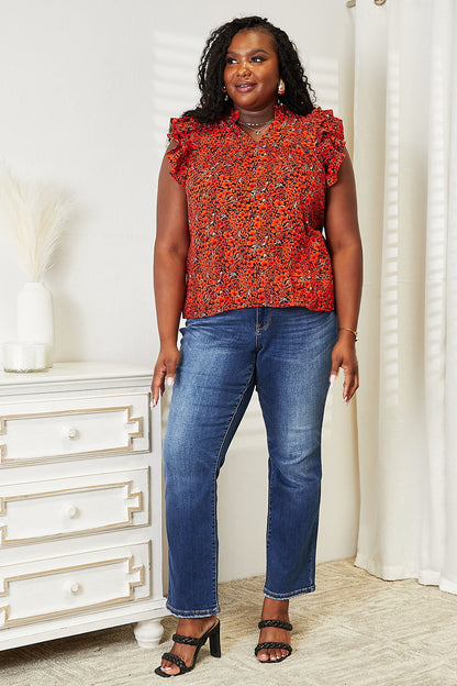 Orange-red floral flutter sleeve blouse with notched neck from Trendsi, showing the stylish design and lightweight fabric.