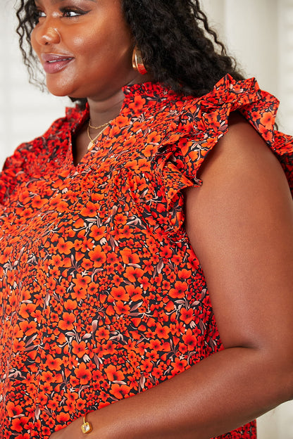 Orange-red floral blouse with flutter sleeves and notched neckline, by Trendsi, displayed on a hanger.
