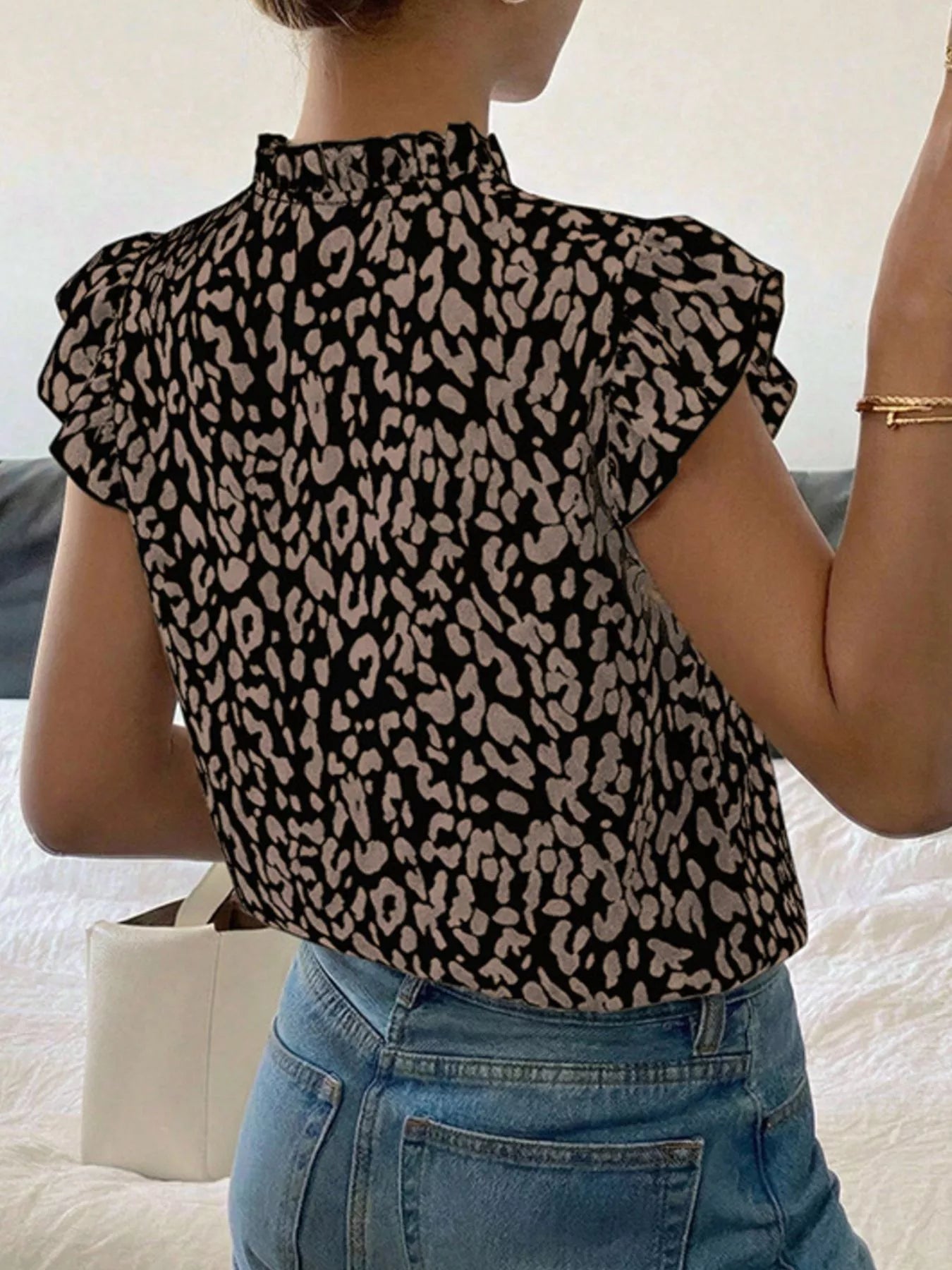 Orange-red leopard print ruffle sleeve blouse by Trendsi, featuring a stylish ruffled design and bold animal print pattern.