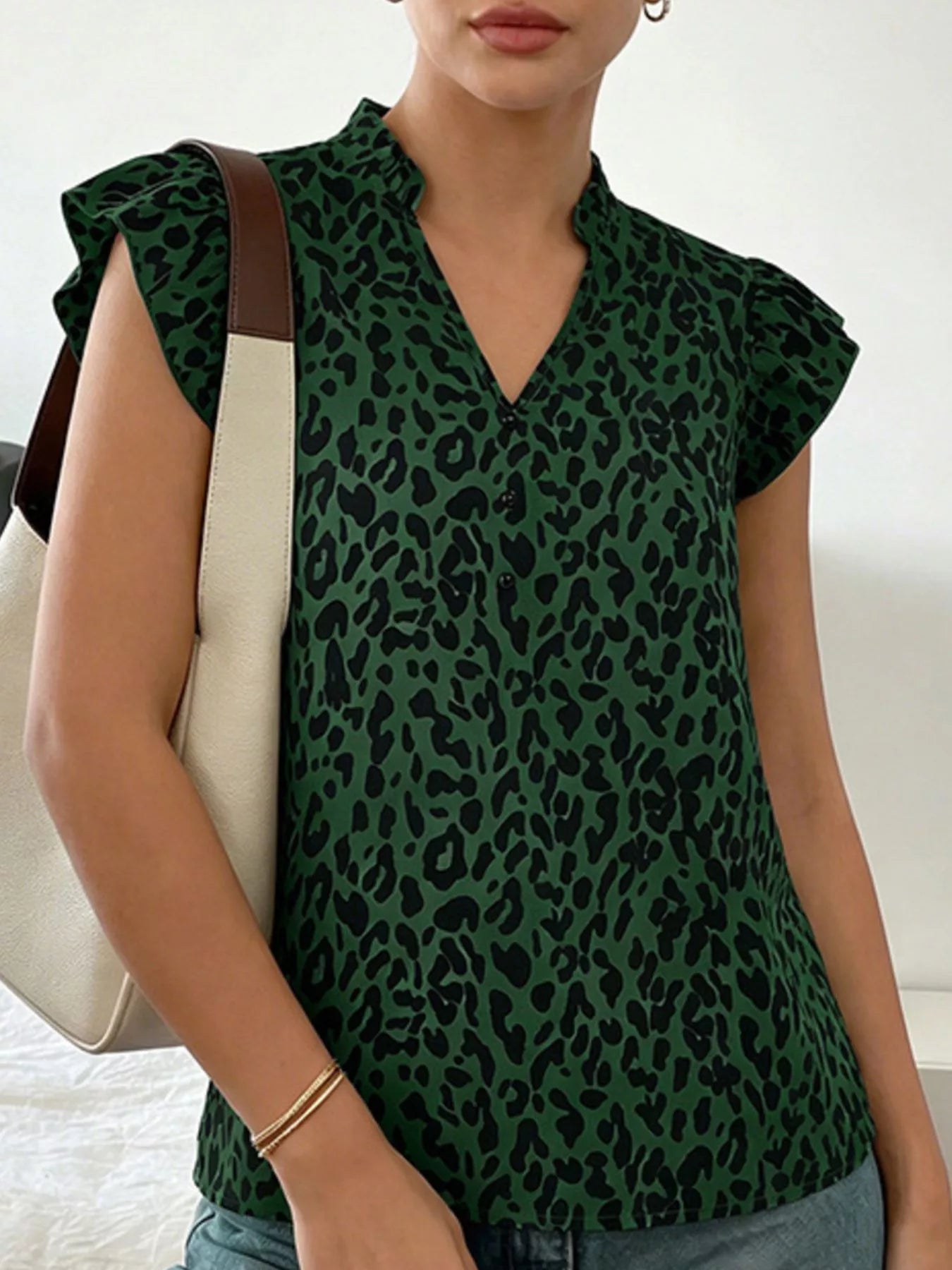 Orange-red leopard print ruffle sleeve blouse by Trendsi, featuring stylish ruffle details and vibrant animal print fabric.