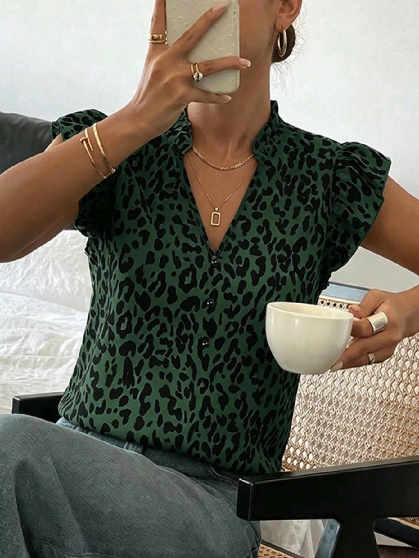 Orange-red leopard print blouse with ruffle sleeves from Trendsi, showcasing stylish sleeve details and bold animal print.