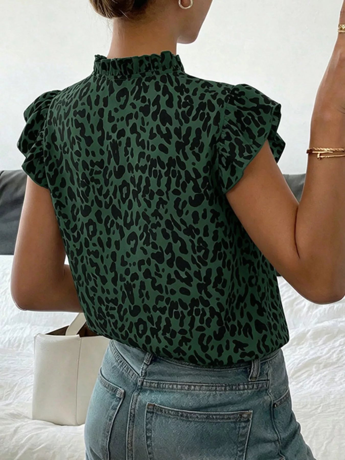 Orange-red leopard print ruffle sleeve blouse from Trendsi, showcasing stylish ruffle details and vibrant animal print fabric.
