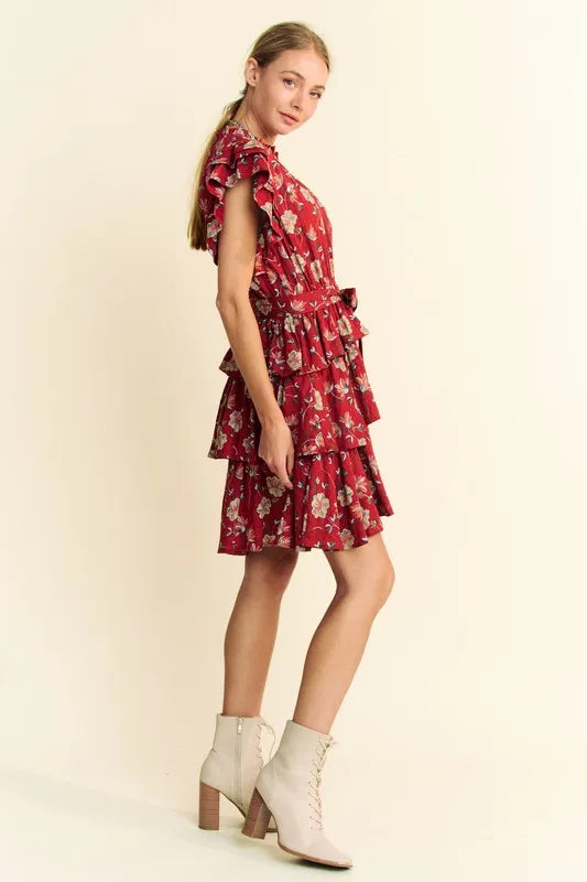 Orange rust mini dress by Davi & Dani featuring ruffle flutter sleeves, tie belt, and tiered design, perfect for warm weather.