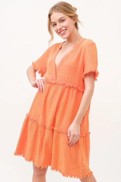 Orange And The Why washed frayed detail tiered dress by Trendsi, featuring a relaxed fit and tiered design with frayed accents.