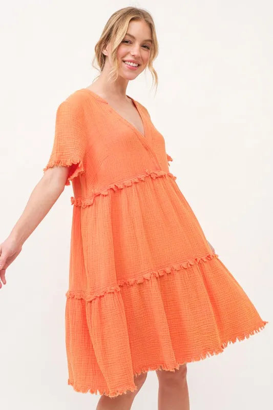 Orange washed frayed detail tiered dress by Trendsi, featuring a relaxed fit with layered fabric and casual, boho-inspired style.