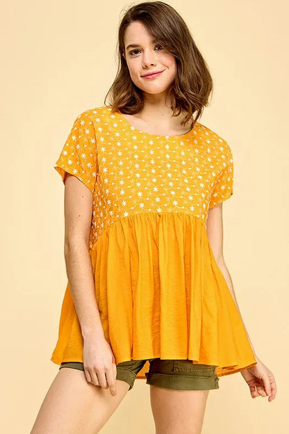 Orange lime 'N' Chili embroidered short sleeve pleated babydoll top by Trendsi, featuring colorful embroidery and a flowy, feminine design.