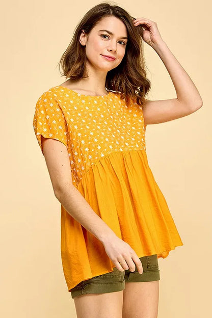 Orange lime 'N' Chili embroidered short sleeve pleated babydoll top by Trendsi, showcasing detailed embroidery and lightweight fabric.