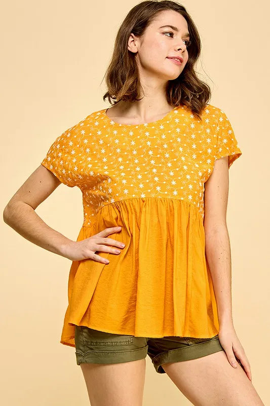 Orange lime 'N' Chili embroidered short sleeve pleated babydoll top by Trendsi, featuring colorful embroidery and a flowy, feminine fit.