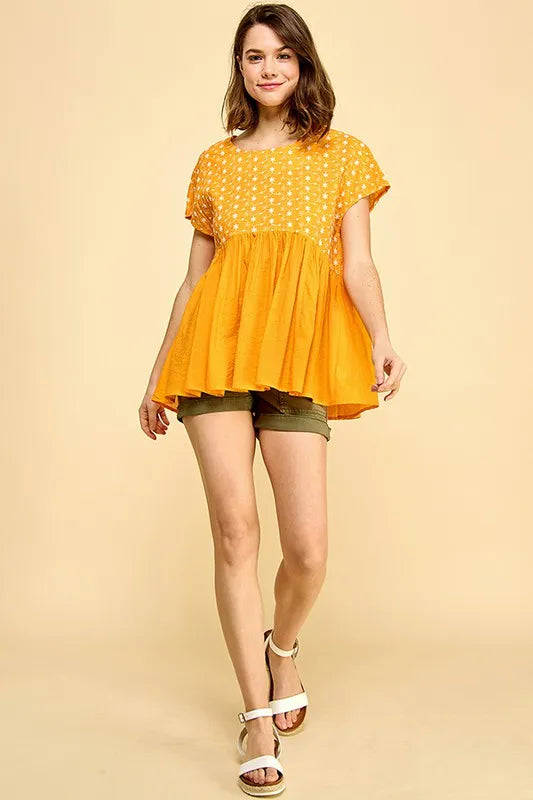 Orange short sleeve babydoll top with lime and chili embroidery, pleated design, by Trendsi.