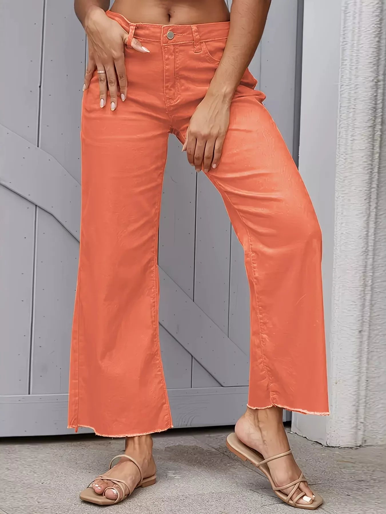 Orange raw hem wide leg jeans from Trendsi with a relaxed fit and distressed detailing, displayed on a white background.