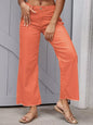 Orange raw hem wide leg jeans from Trendsi with a relaxed fit and distressed detailing, displayed on a white background.