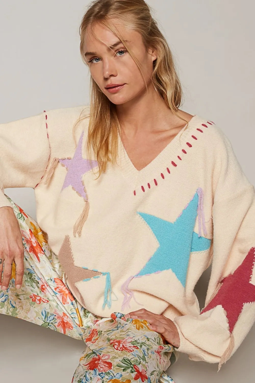 Pale beige POL V-neck long sleeve star fringe sweater by Trendsi featuring a cozy knit design and subtle star accents.