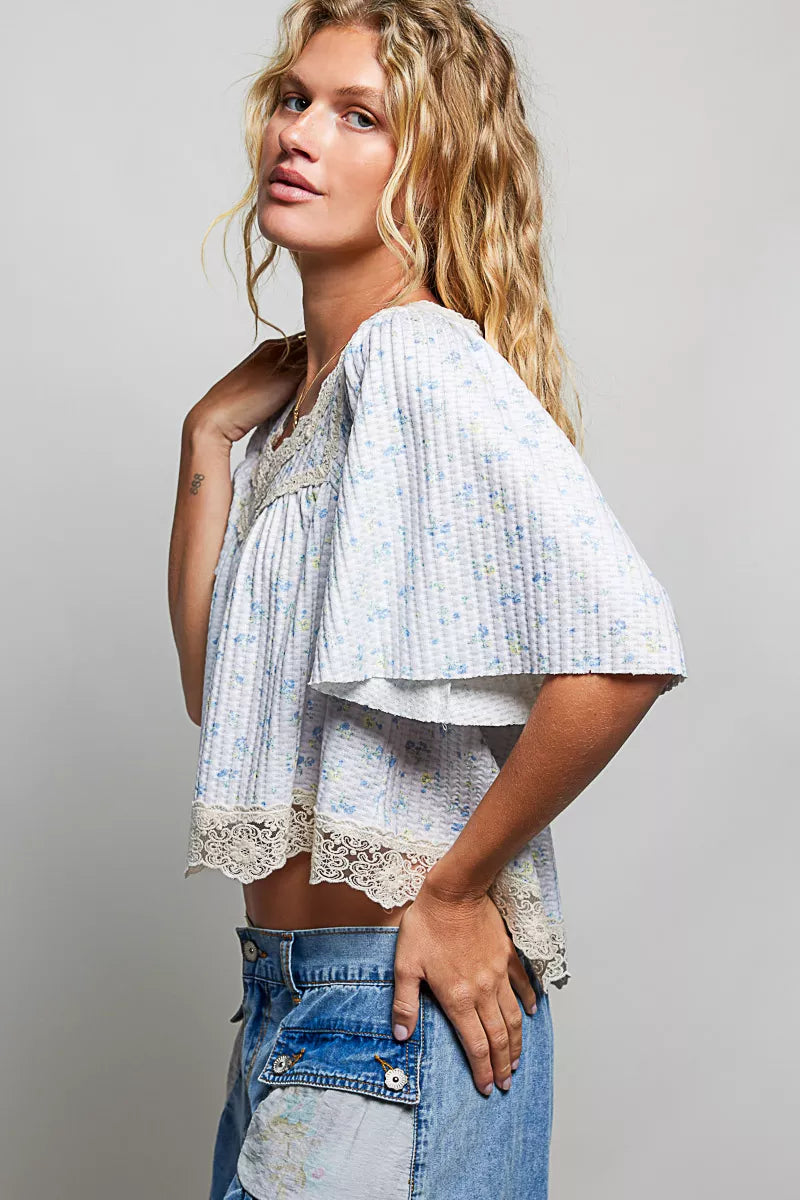 Pale blue floral print lace trim blouse from Trendsi featuring long sleeves and a relaxed fit.