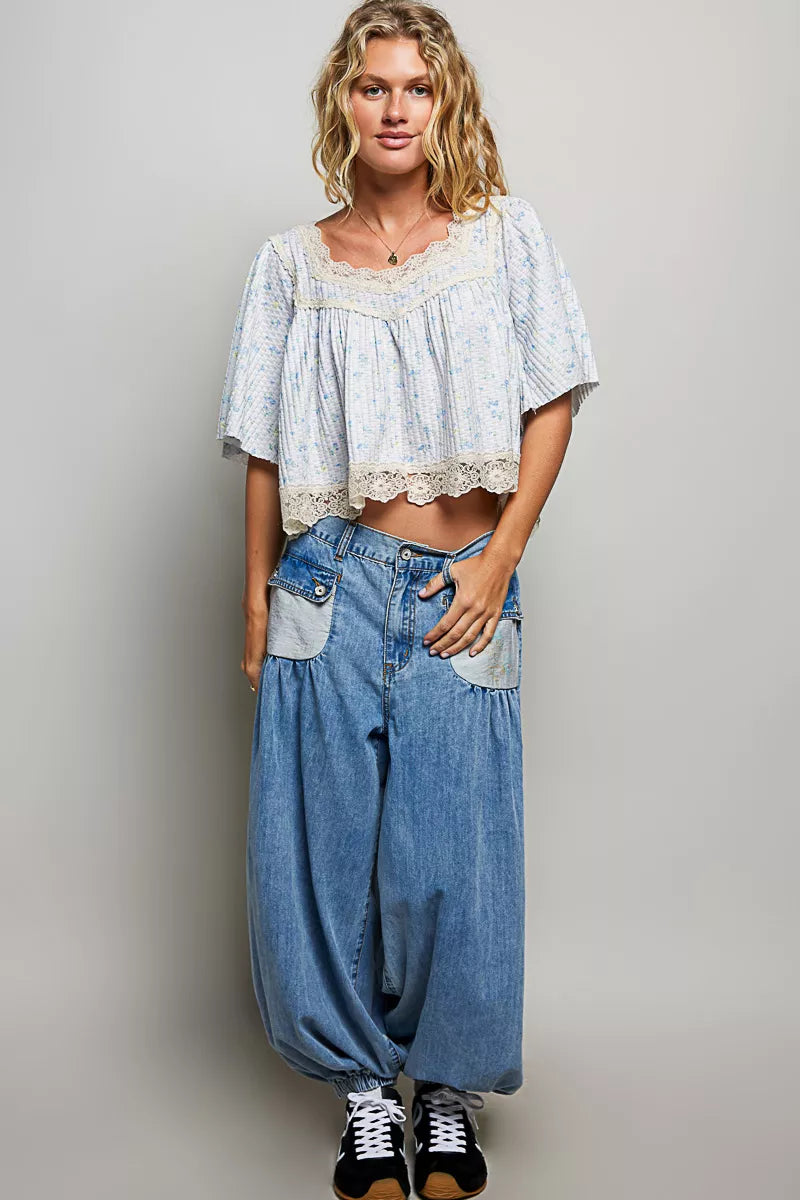 Pale blue floral print lace trim blouse from Trendsi, featuring delicate lace details and a soft, elegant design.