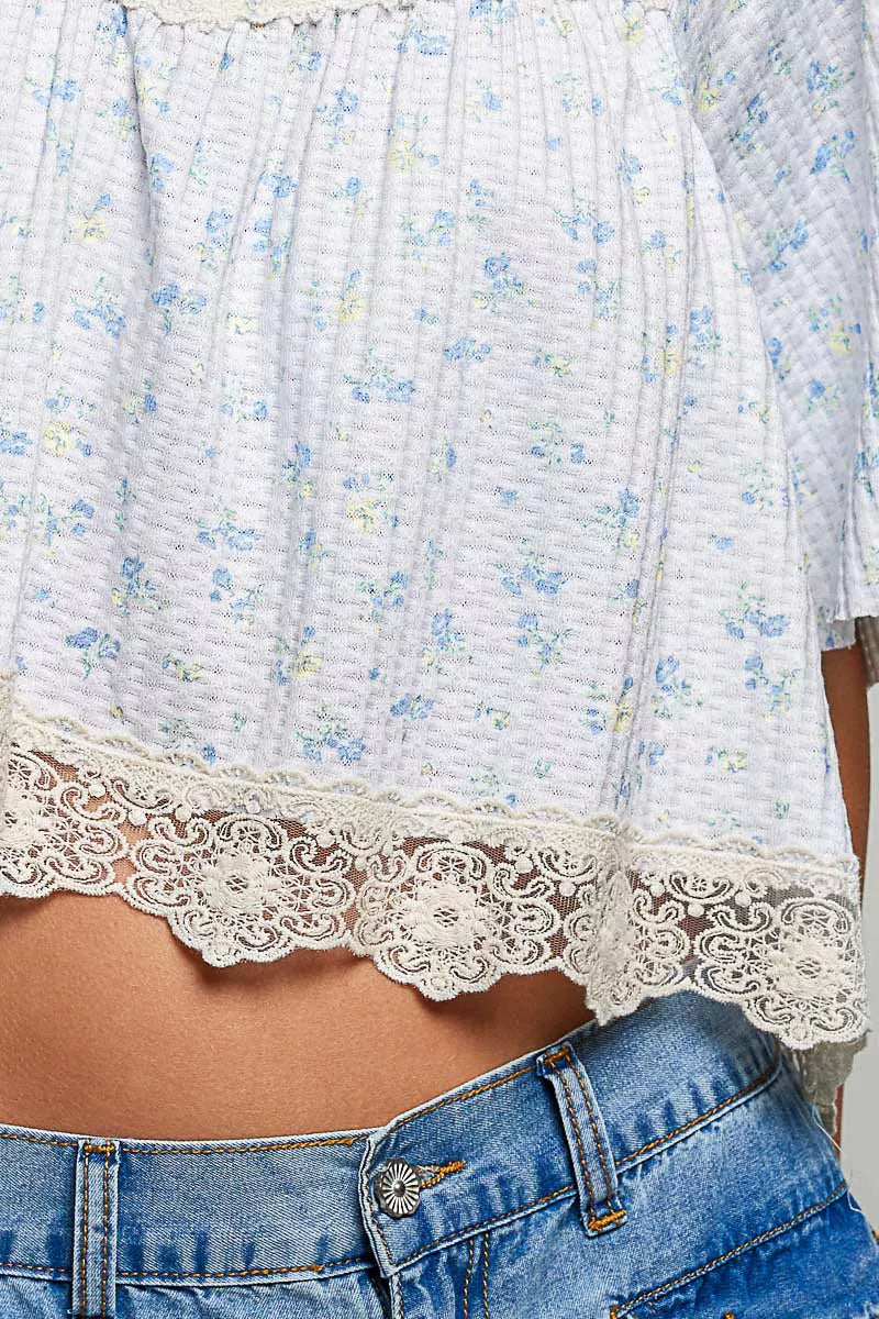 Pale blue floral print lace trim blouse from Trendsi, featuring intricate lace details and lightweight fabric.