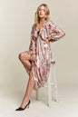 Pale blush ADORA printed V-neck batwing sleeve dress by Trendsi, featuring a flowy silhouette and stylish pattern.