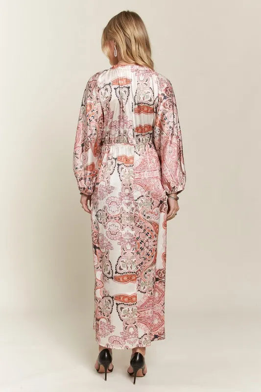 Pale blush ADORA printed V-neck batwing sleeve dress by Trendsi, featuring a relaxed fit and stylish pattern.