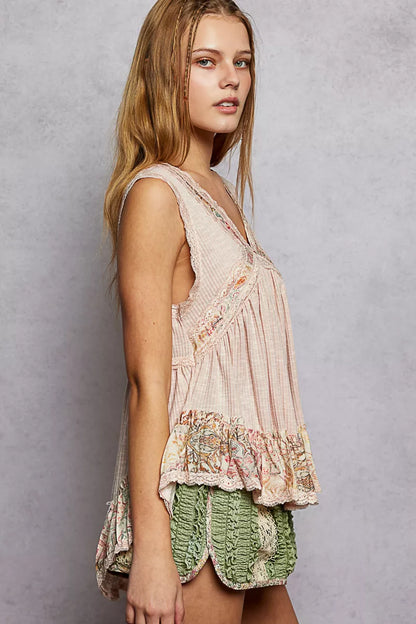 Pale pink Trendsi sleeveless top with lace details, ruffled ribbed fabric, and floral pattern trim, stylish and feminine.