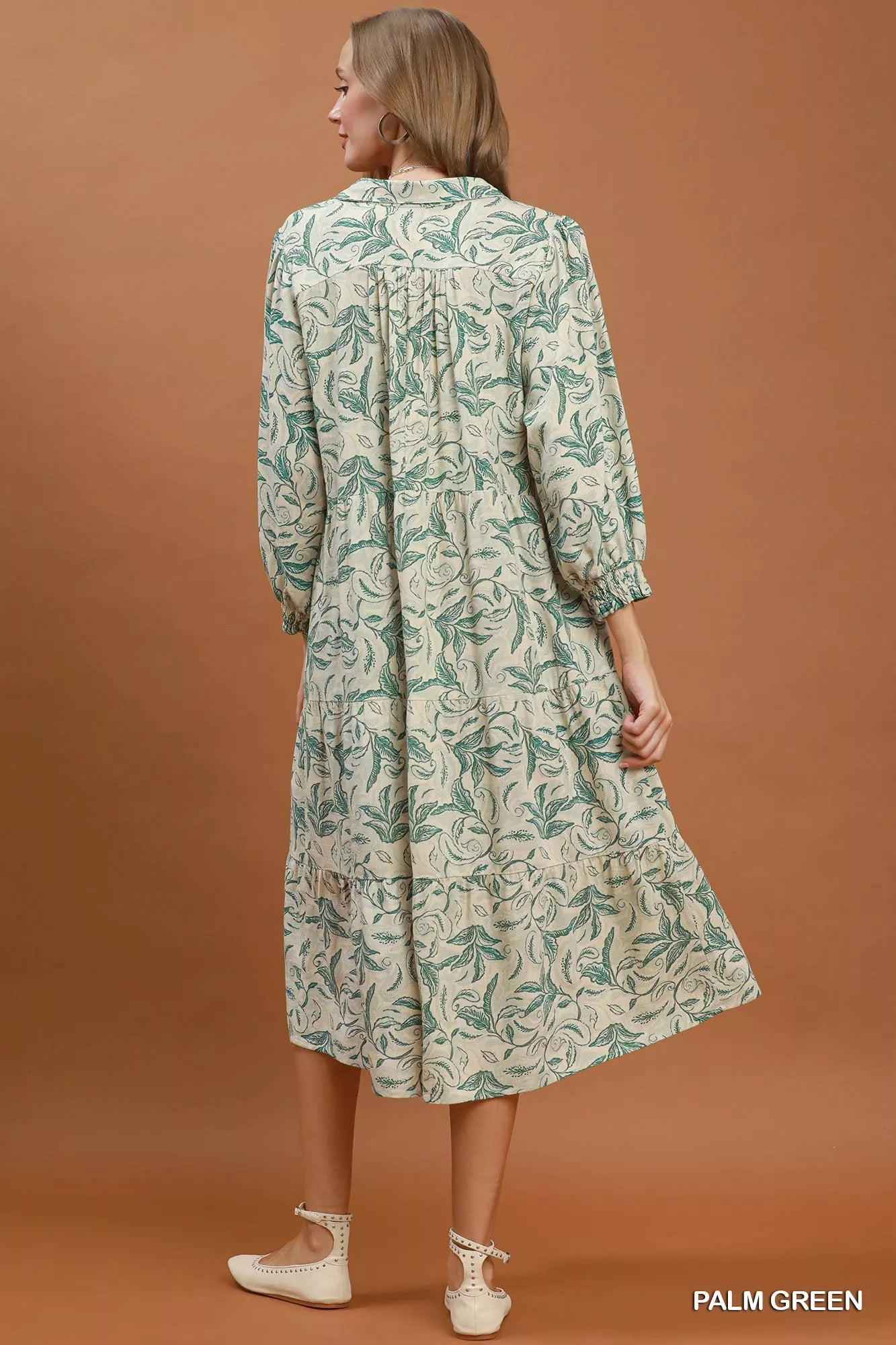 Light green linen tiered midi dress with botanical print and sleeveless design from Umgee. Perfect for warm weather.