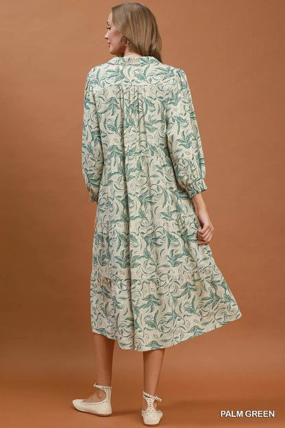 Light green linen tiered midi dress with botanical print and sleeveless design from Umgee. Perfect for warm weather.
