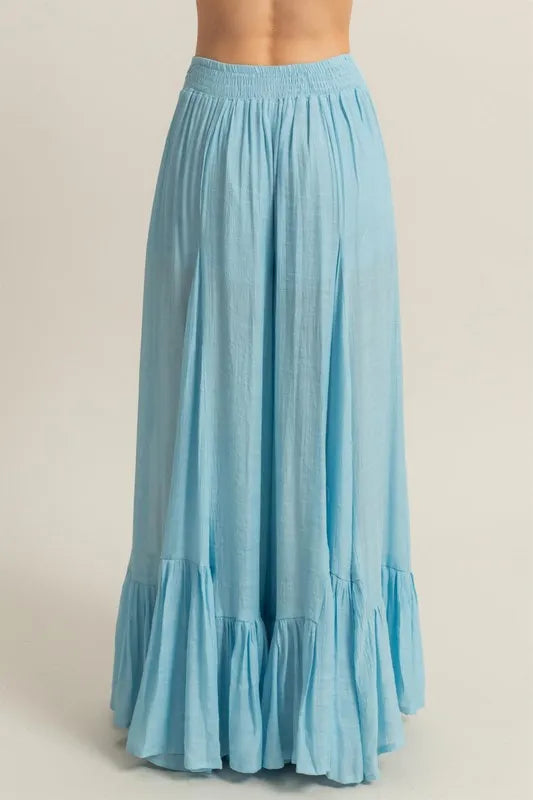 Pastel blue HYFVE high-waist ruffle flared wide-leg pants with flowy fabric and stylish ruffle details.