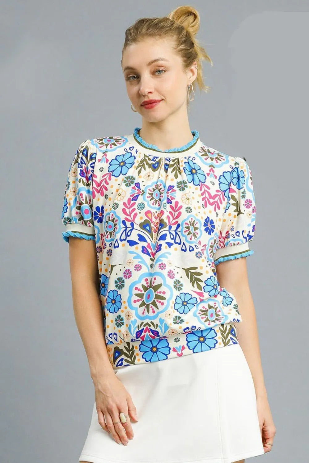 Pastel blue Umgee retro floral puff sleeve top with ruffled details, displayed on a model, perfect for casual or boho styles.
