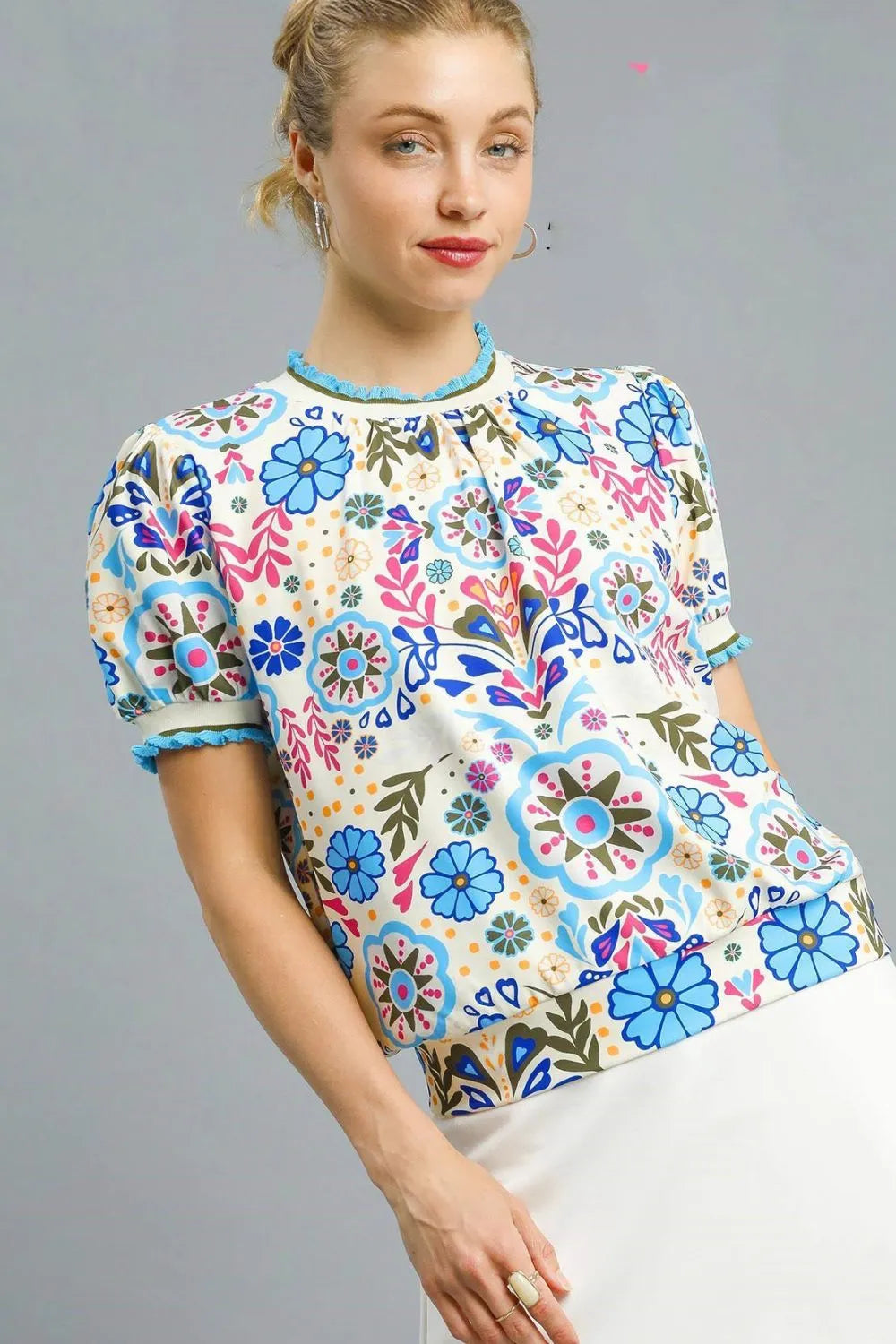 Pastel blue Umgee Retro Floral Puff Sleeve Top with a relaxed fit, featuring vintage-inspired floral print and puffed sleeve design.