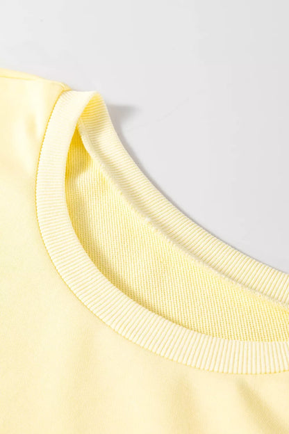 Pastel yellow round neck half sleeve T-shirt dress by Trendsi, casual and comfortable for everyday wear.