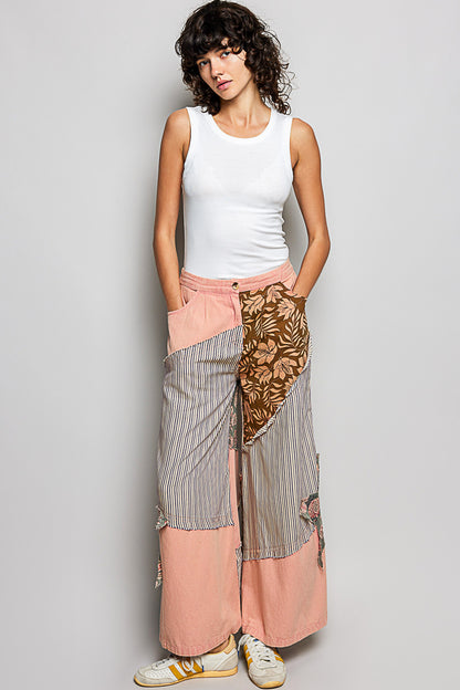 Trendi peach multi striped floral patchwork wide-leg pants with side big star patch and relaxed fit.