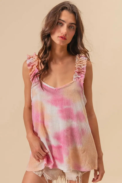Peach pink BiBi tie-dye printed textured woven fabric with ruffled details, showcasing trendy boho style.