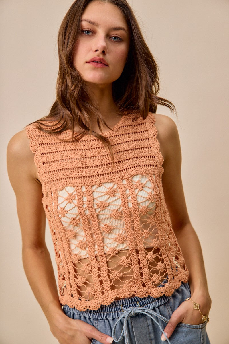 Peach crochet knitted lace sweater tank top by Trendsi, lightweight and stylish with intricate lace details, sleeveless design.