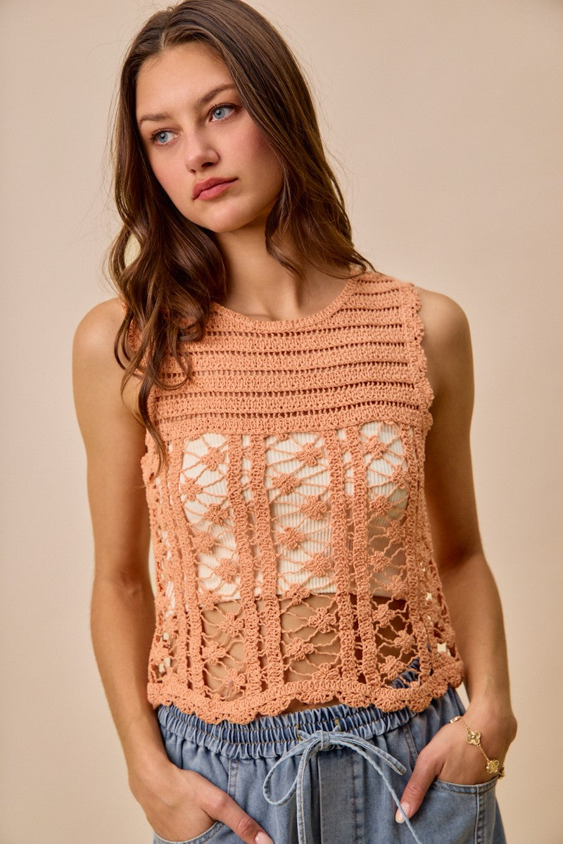 Peach crochet knitted lace sweater tank top by Trendsi, featuring delicate lace details and sleeveless design for a stylish look.