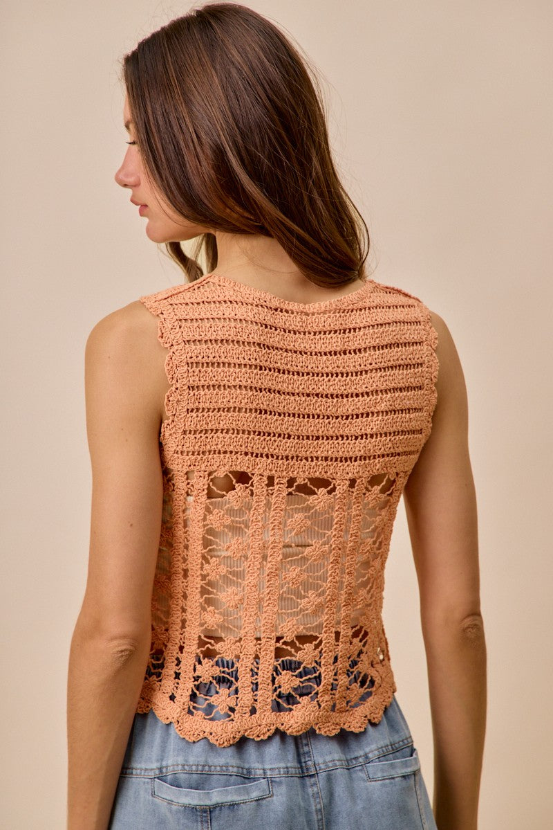 Peach crochet knitted lace sweater tank top by Trendsi, featuring delicate lace detailing and a sleeveless design for a casual look.