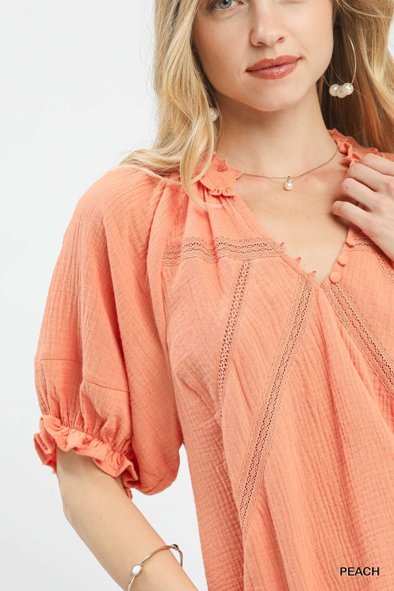 Peach Umgee cotton gauze ruffle top with short sleeves and a relaxed fit, designed by Trendsi.
