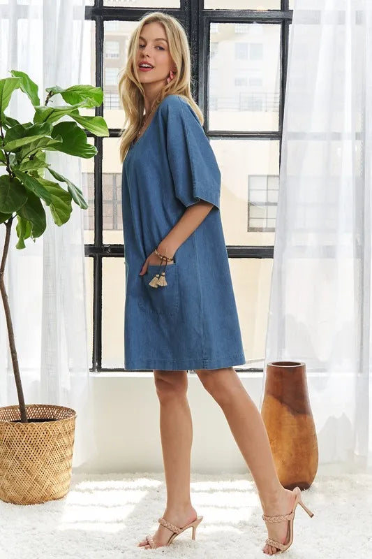 Peacock blue ADORA V-neck half sleeve mini denim dress by Trendsi, showing a stylish, fitted silhouette with a V-neckline and short sleeves.