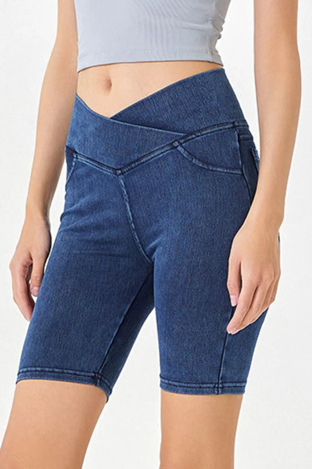 Peacock blue basic Bae asymmetrical waist denim shorts with pockets from Trendsi, featuring a stylish, casual fit and distressed details.