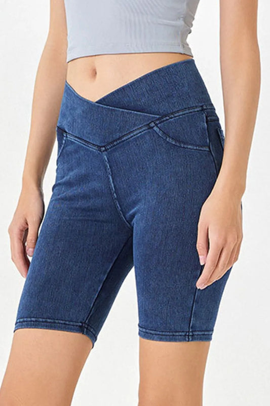 Peacock blue basic Bae asymmetrical waist denim shorts with pockets from Trendsi, featuring a stylish, casual fit and distressed details.